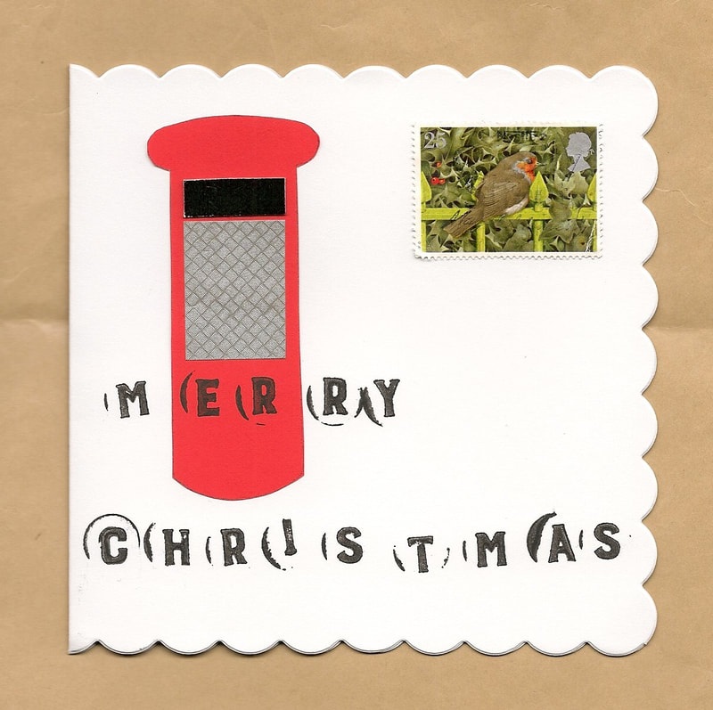 Scan of a white card with a red postbox on it.  The words "Merry Christmas" are written across it so that the E and the R are over the middle of the postbox, like the royal cypher.  There is also a postage stamp with a robin on it.