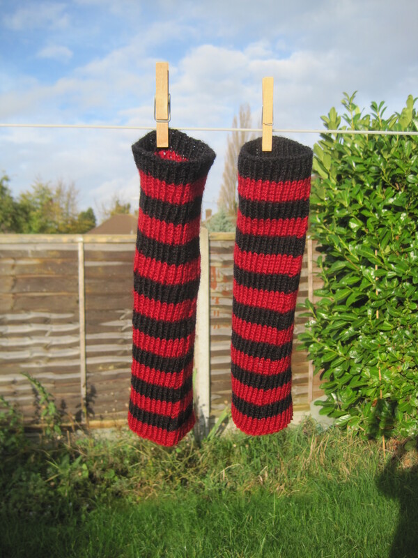Red and black striped knitted tubes.